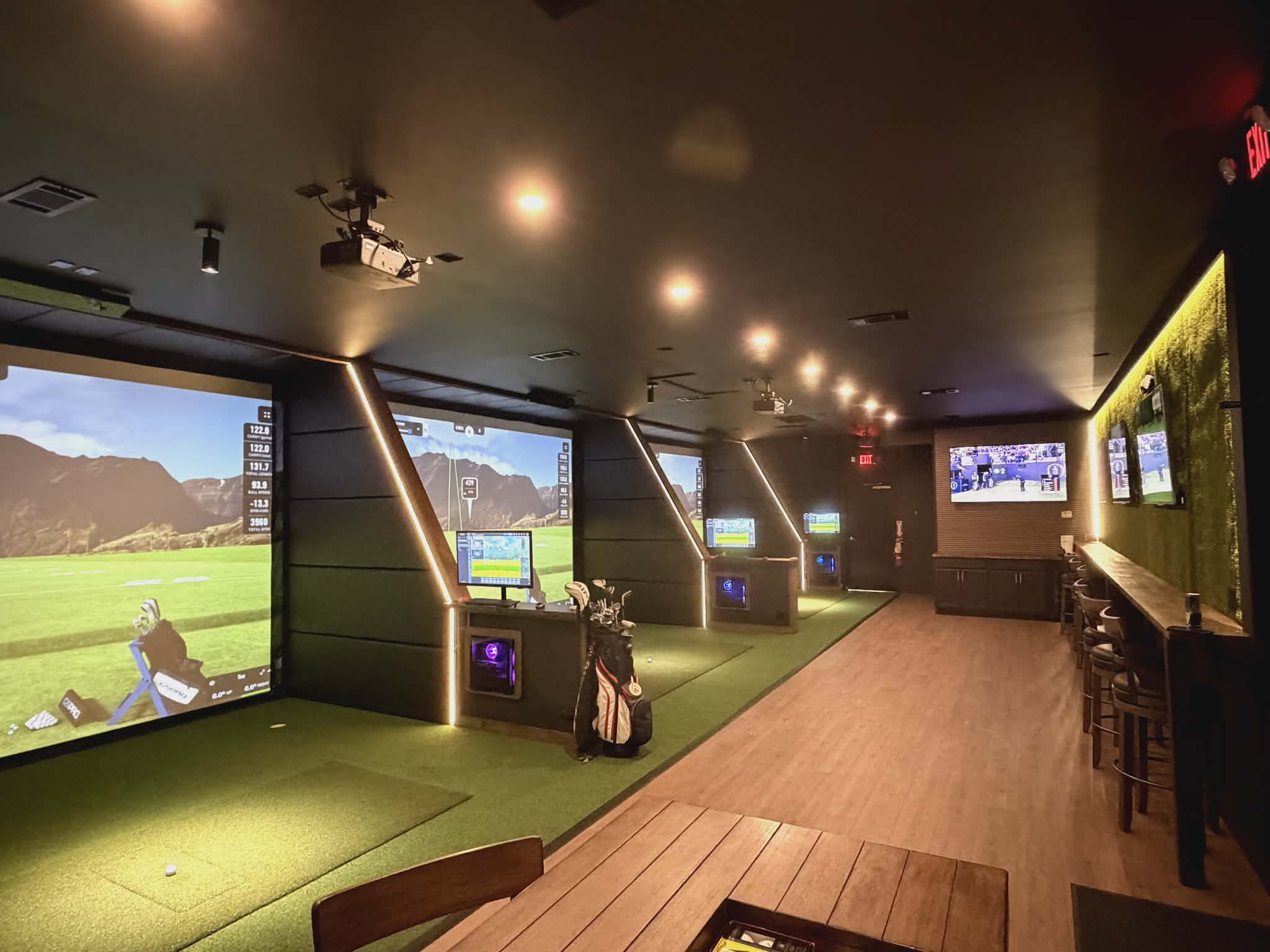 SWNG Golf Club multiple simulator bays with seating areas